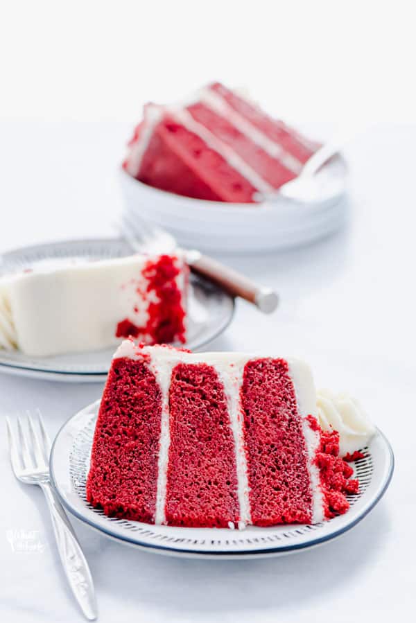 Slices of Gluten Free Red Velvet Cake on small white plates