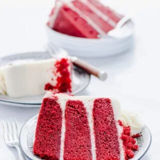 Slices of Gluten Free Red Velvet Cake on small white plates