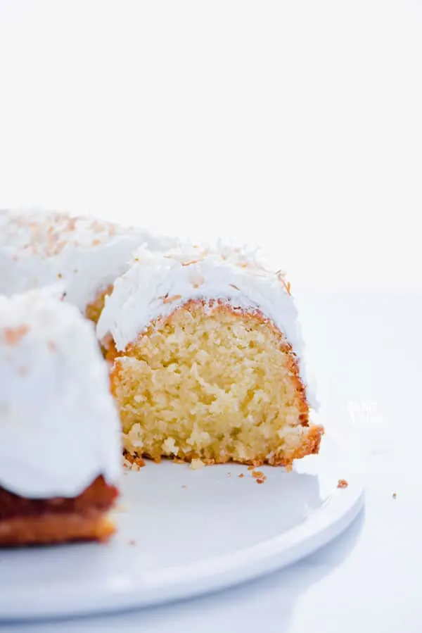 This is a simple, easy recipe for Coconut Pound Cake - aka Coconut Bundt Cake. It’s full of coconut flavor from coconut extract and shredded coconut and is topped with the most delicious, creamy coconut icing and garnished with toasted coconut. It’s a perfect dessert for a crowd or for holidays, birthday cake, and gatherings. It’s moist, dense, and has a tender crumb that’s addicting. Gluten Free Cake recipe from @whattheforkblog - visit whattheforkfoodblog.com for more gluten free desserts.