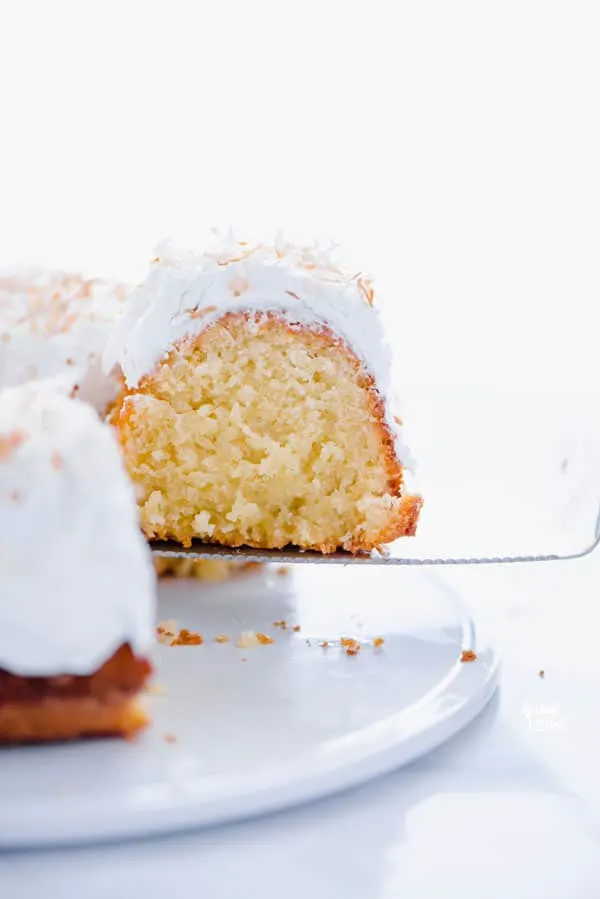 This is a simple, easy recipe for Coconut Pound Cake - aka Coconut Bundt Cake. It’s full of coconut flavor from coconut extract and shredded coconut and is topped with the most delicious, creamy coconut icing and garnished with toasted coconut. It’s a perfect dessert for a crowd or for holidays, birthday cake, and gatherings. It’s moist, dense, and has a tender crumb that’s addicting. Gluten Free Cake recipe from @whattheforkblog - visit whattheforkfoodblog.com for more gluten free desserts.