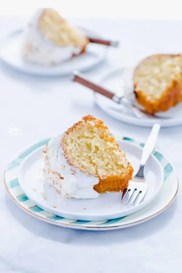 This is a simple, easy recipe for Coconut Pound Cake - aka Coconut Bundt Cake. It’s full of coconut flavor from coconut extract and shredded coconut and is topped with the most delicious, creamy coconut icing and garnished with toasted coconut. It’s a perfect dessert for a crowd or for holidays, birthday cake, and gatherings. It’s moist, dense, and has a tender crumb that’s addicting. Gluten Free Cake recipe from @whattheforkblog - visit whattheforkfoodblog.com for more gluten free desserts.