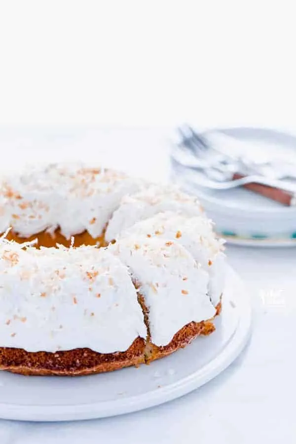 This is a simple, easy recipe for Coconut Pound Cake - aka Coconut Bundt Cake. It’s full of coconut flavor from coconut extract and shredded coconut and is topped with the most delicious, creamy coconut icing and garnished with toasted coconut. It’s a perfect dessert for a crowd or for holidays, birthday cake, and gatherings. It’s moist, dense, and has a tender crumb that’s addicting. Gluten Free Cake recipe from @whattheforkblog - visit whattheforkfoodblog.com for more gluten free desserts.