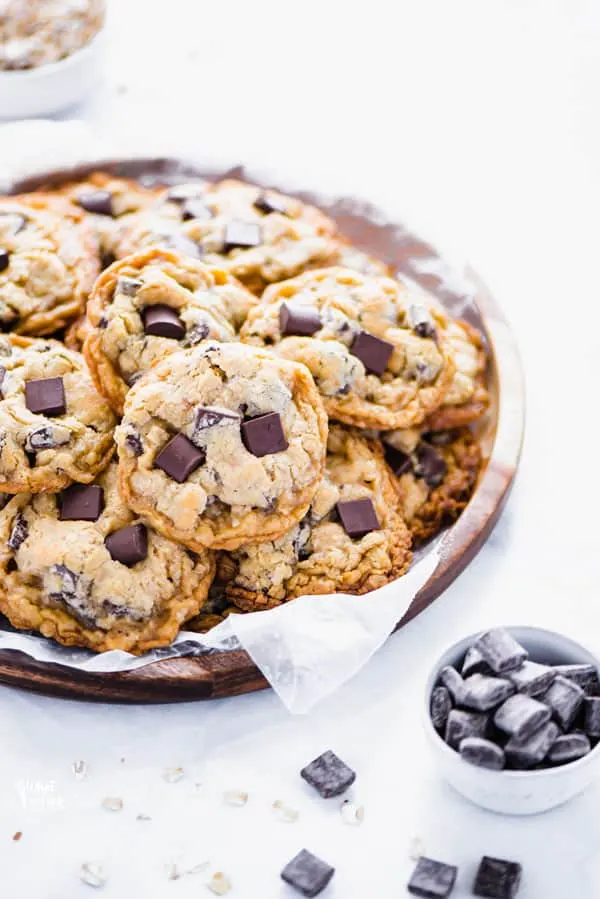 Bakery style gluten free oatmeal chocolate chip cookies are legit irresistible. They’re crisp on the edges and soft in the middle with just the right amount of chewiness from the old fashioned oats. While these cookies are gloriously buttery, these oatmeal cookies can be made dairy free too! If you’ve been searching for the perfect gluten free cookie, this is it! Gluten Free Cookie recipe from @whattheforkblog - visit whattheforkfoodblog.com for more gluten free dessert recipes!