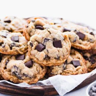 Gluten Free Oatmeal Chocolate Chip Cookies on a round wood platter lined with wax paper