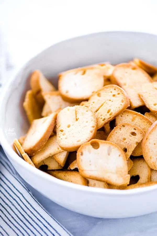 Learn how to make your own homemade bagel chips! Making your own bagel chips saves you money and you can control the seasonings. This recipe is for plain bagel chips (to be used in homemade Chex Mix!) but you can change up the seasonings and spices to suit your taste. I used gluten free bagels to make these simple bagel chips but it works with regular bagels too. Recipe from @whattheforkblog - visit whattheforkfoodblog.com for more!