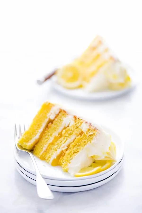 This simple Gluten Free Lemon Cake is one of THE BEST cakes I’ve ever had! Moist, tender cake layered with lemon curd and cream cheese frosting. It’s absolutely delicious and you’d never know it was gluten free! This recipe makes 2 6-inch cake layers that are sliced and turned into a 4 layer cake. You can double the recipe and bake it as a 9 inch cake or 8 inch cake. This lemon cake recipe is perfect for Easter, Mother’s Day, graduation parties, wedding showers, baby showers, and birthday cakes.