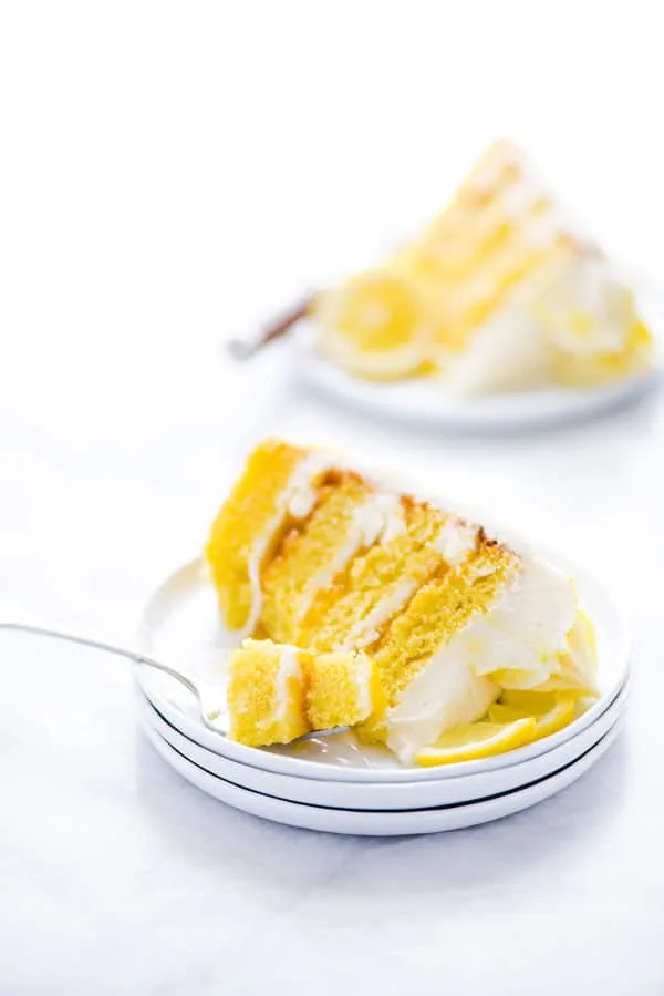 This simple Gluten Free Lemon Cake is one of THE BEST cakes I’ve ever had! Moist, tender cake layered with lemon curd and cream cheese frosting. It’s absolutely delicious and you’d never know it was gluten free! This recipe makes 2 6-inch cake layers that are sliced and turned into a 4 layer cake. You can double the recipe and bake it as a 9 inch cake or 8 inch cake. This lemon cake recipe is perfect for Easter, Mother’s Day, graduation parties, wedding showers, baby showers, and birthday cakes.