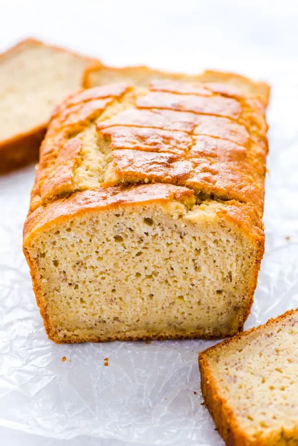 a loaf of Gluten Free Sourdough Discard Banana Bread on a piece of wax paper