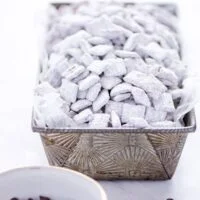 Gluten Free Puppy Chow in a silver loaf pan for serving