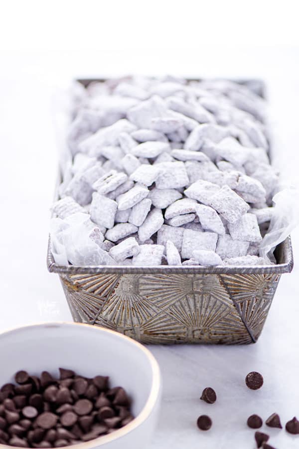 Gluten Free Puppy Chow in a silver loaf pan for serving