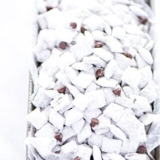 Super simple Gluten Free Puppy Chow - AKA Muddy Buddies is everyone’s favorite sweet snack. You only need a few ingredients to make it - Chex cereal, chocolate chips, butter, vanilla, peanut butter, and powdered sugar. You can even make vegan muddy buddies by using vegan butter and dairy free chocolate chips. This no bake recipe takes less than 15 minutes to make too! The recipe calls for semi-sweet chocolate but you can use milk chocolate or dark chocolate if you prefer.