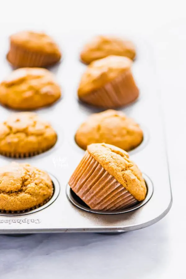 Gluten Free Sweet Potato Muffins in a silver muffin tin cooling after coming out of the oven