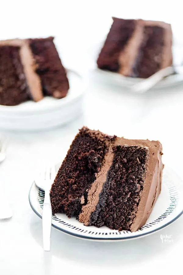 3 pieces of gluten free chocolate cake on plates ready to be served