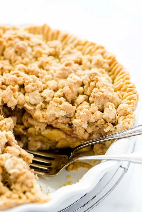 Gluten free apple crisp pie with a piece removed and two forks in it's place