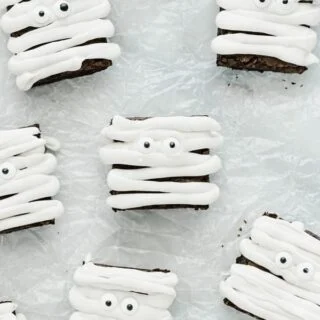 Gluten Free Mummy Brownies decorated for Halloween on crinkled wax paper