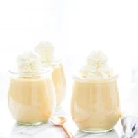 Homemade Maple Pudding in individual weck jars topped with whipped cream