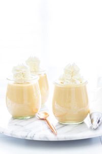Homemade Maple Pudding in individual weck jars topped with whipped cream