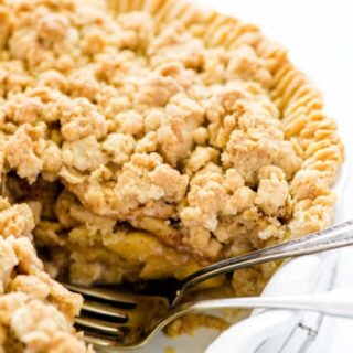 Gluten free apple crisp pie with a piece removed and two forks in it's place