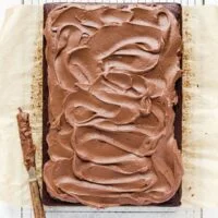 Chocolate Cream Cheese Frosting spread on a chocolate sheet cake