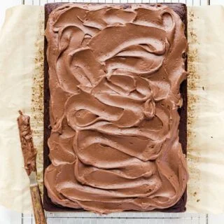 Chocolate Cream Cheese Frosting spread on a chocolate sheet cake