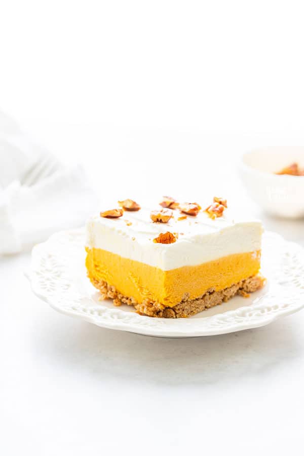 a slice of gluten free pumpkin lush cake on a white plate