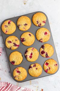 baked gluten free white chocolate cranberry muffins in a metal muffin tin