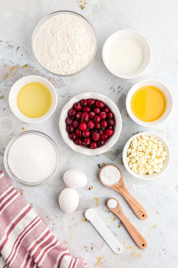 ingredients in individual bowls for white chocolate cranberry muffins
