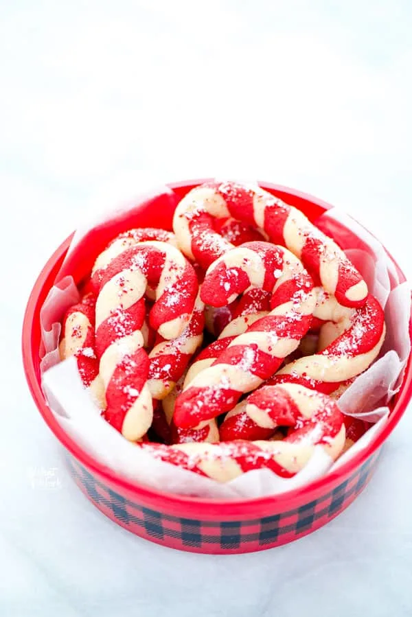 gluten free candy cane cookies in a buffalo plaid cookie tin