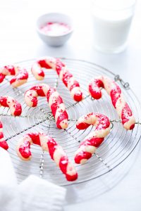 gluten free candy cane cookies cooling on a round metal wire rack