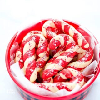 gluten free candy cane cookies in a buffalo plaid cookie tin