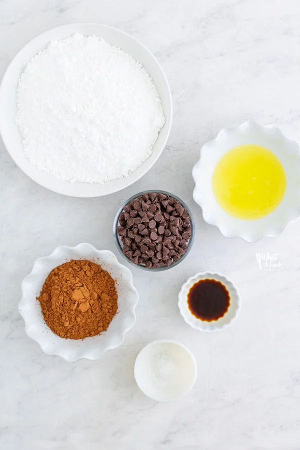 ingredients for flourless chocolate cookies in individual bowls