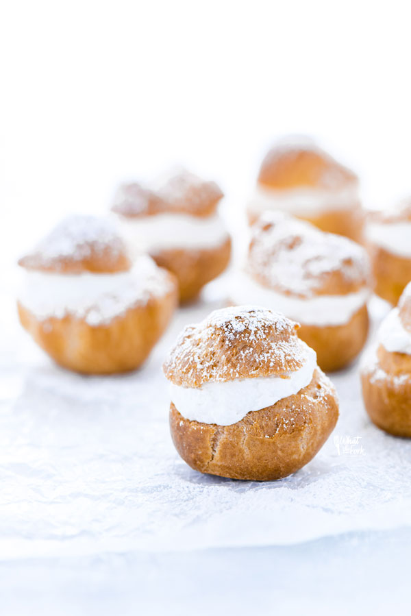 gluten free Choux Pastry shells filled with whipped cream and topped with powdered sugar for Cream Puffs