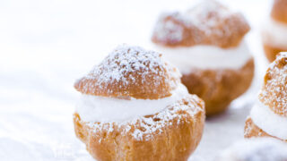 Baked and ready to serve Gluten Free Cream Puff Recipe dusted with powdered sugar