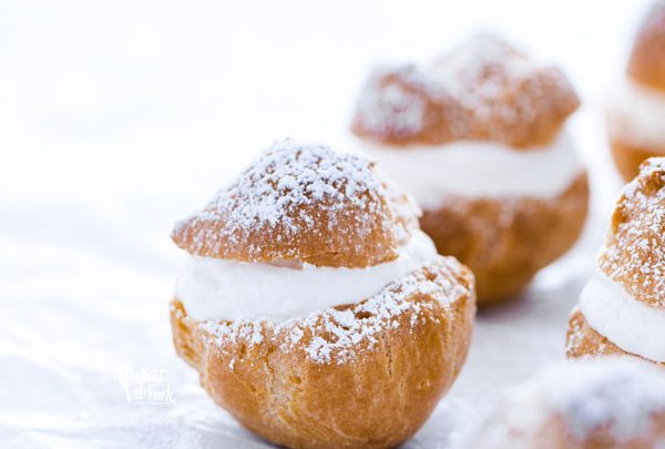 Baked and ready to serve Gluten Free Cream Puff Recipe dusted with powdered sugar