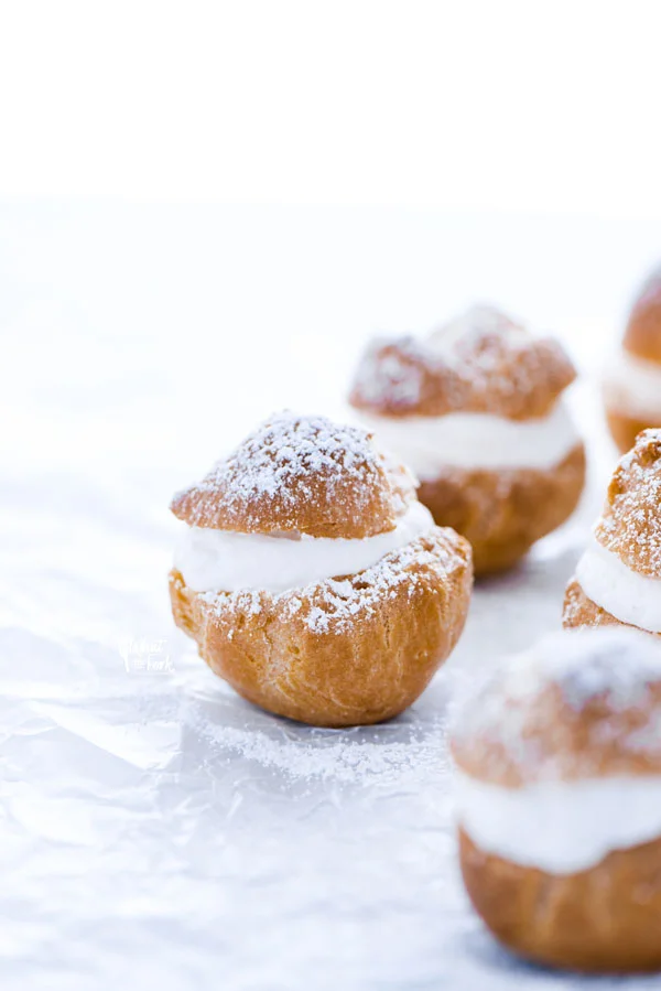 Baked and ready to serve Gluten Free Cream Puff Recipe dusted with powdered sugar