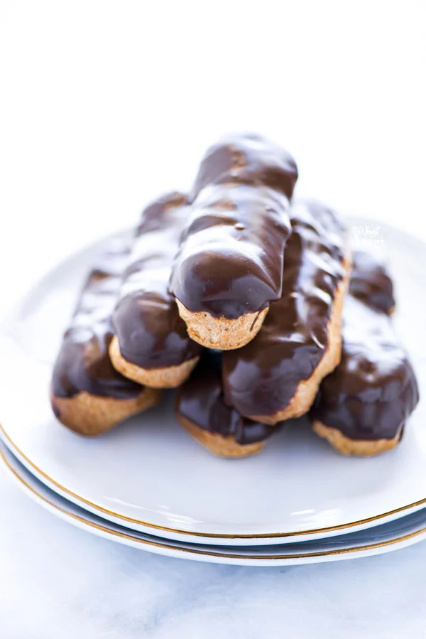 baked and stacked gluten free chocolate eclair recipe ready to serve on a white plate