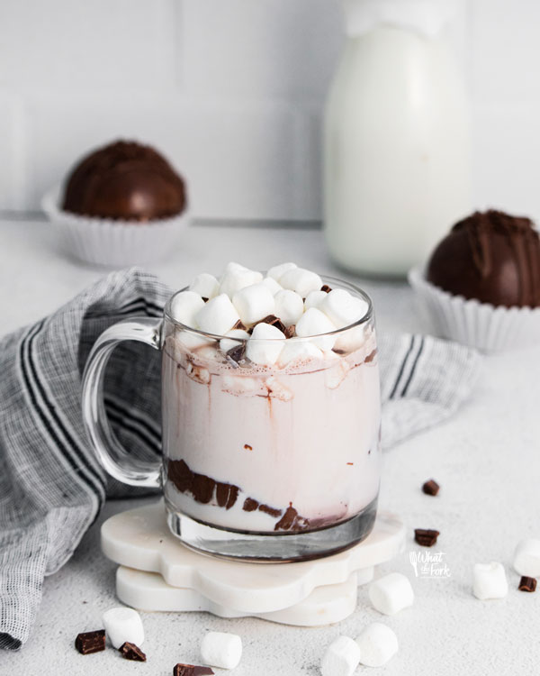 hot chocolate bombs turned into hot cocoa in a clear class mug