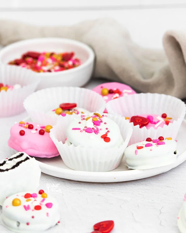 Valentine's Chocolate Covered Oreos in white paper wrappers on a white plate