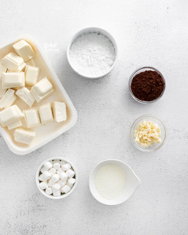 ingredients for white hot chocolate bombs in individual bowls