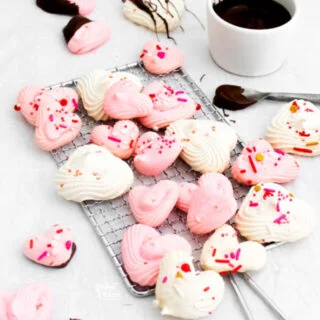 baked heart meringue cookies on a small wire rack
