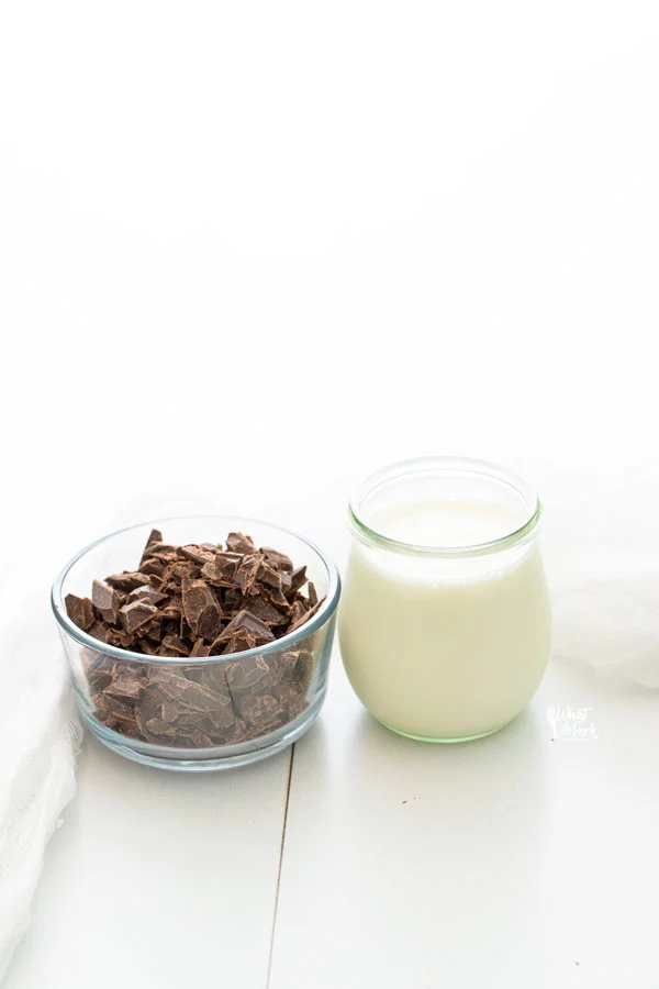 ingredients for a simple chocolate ganache recipe in separate glass containers