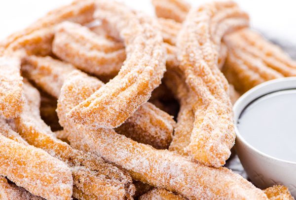 gluten free churros recipe on a wood platter ready to be served