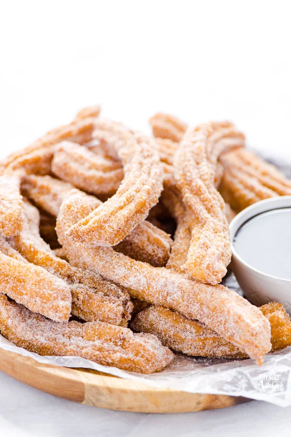 gluten free churros recipe on a wood platter ready to be served
