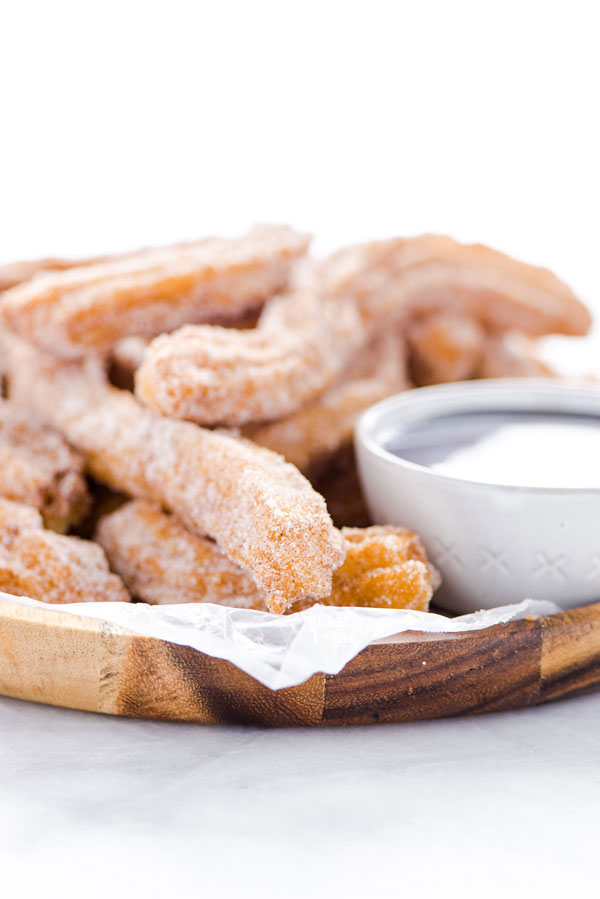 Gluten Free Churros Recipe on a wood platter ready to be served