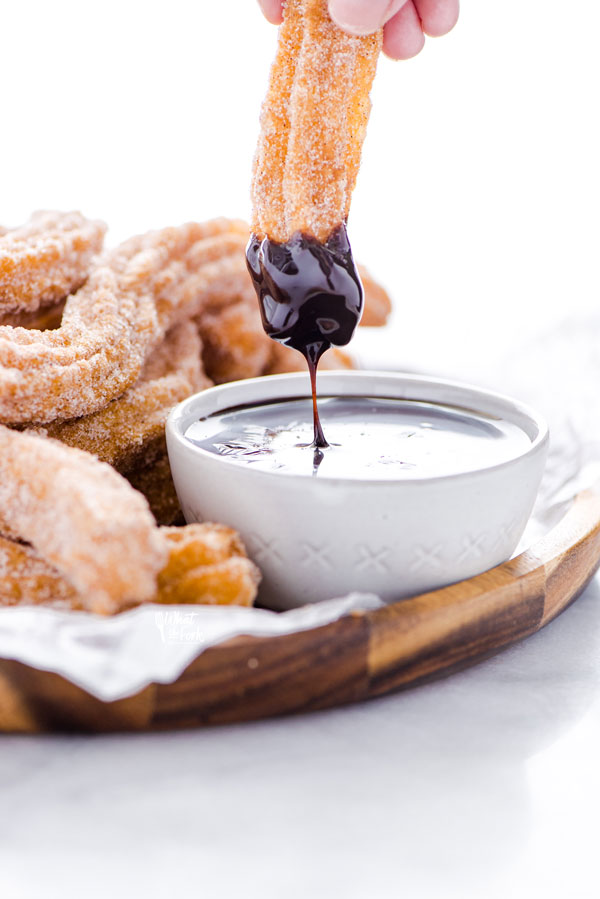 a gluten free churro that's been dipped in chocolate sauce