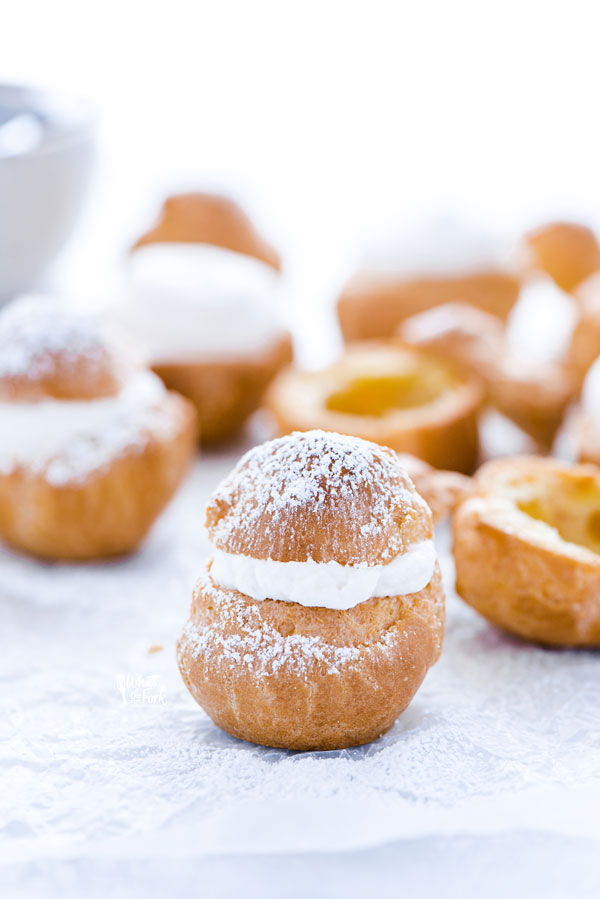 a gluten free cream puff topped with powdered sugar ready to serve
