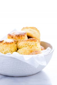 gluten free scones in a white bowl lined with a white napkin