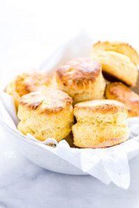 gluten free scones in a white bowl lined with a white napkin
