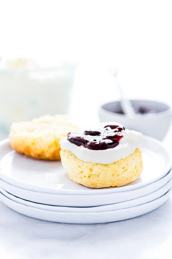 a gluten free scone split in half and topped with clotted cream and jam