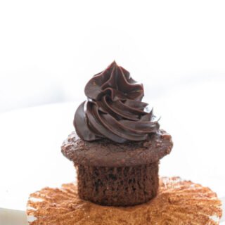 chocolate ganache pipped onto a chocolate cupcake